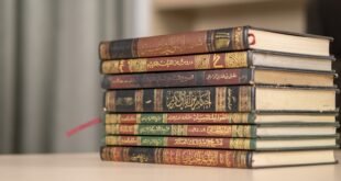 a stack of books sitting on top of a table