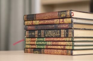 a stack of books sitting on top of a table