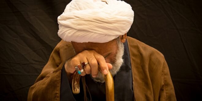 person in brown coat and white knit cap